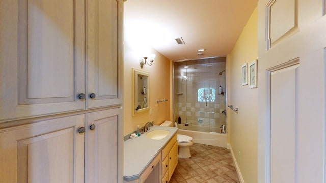 full bathroom with vanity, tiled shower / bath combo, and toilet