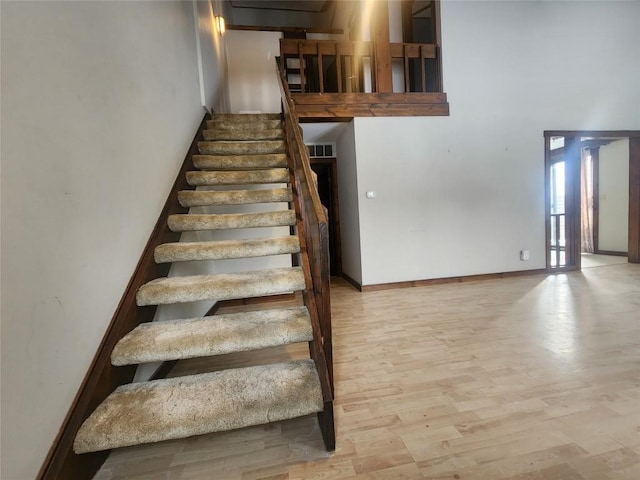 stairs featuring hardwood / wood-style flooring