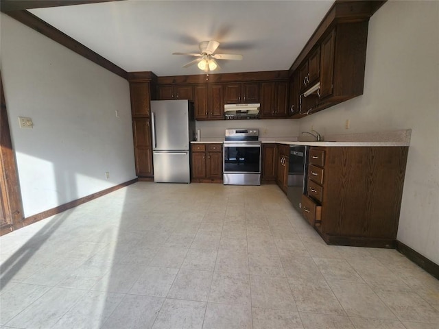 kitchen featuring light tile patterned floors, ceiling fan, appliances with stainless steel finishes, dark brown cabinets, and sink