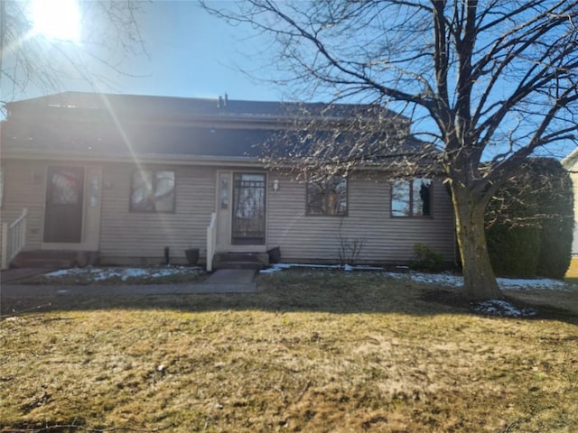 view of front of property with entry steps and a front yard