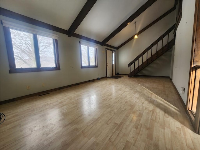 unfurnished living room featuring stairs, lofted ceiling with beams, wood finished floors, and visible vents