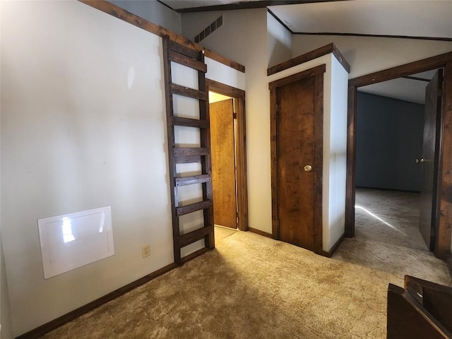 carpeted spare room with lofted ceiling