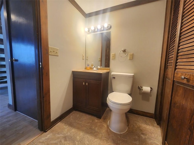 bathroom featuring toilet, vanity, and tile patterned flooring