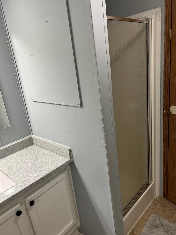 263 W Jamestown Rd, Jamestown, PA 16134 - bathroom with a stall shower, vanity, and tile patterned floors