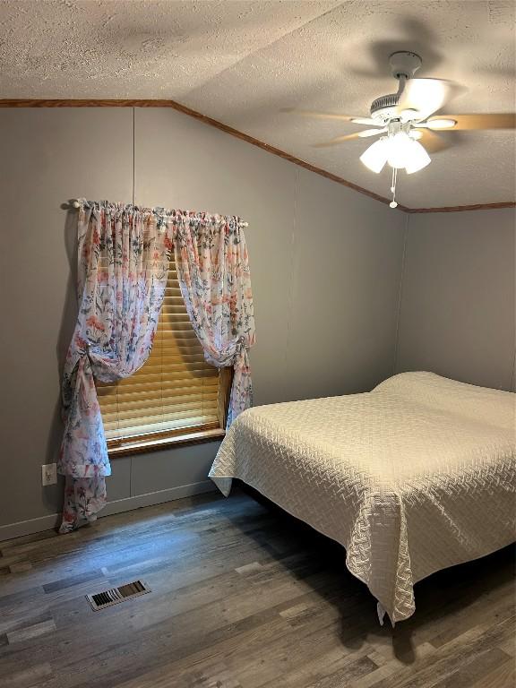 263 W Jamestown Rd, Jamestown, PA 16134 - bedroom featuring crown molding, lofted ceiling, wood finished floors, a ceiling fan, and a textured ceiling