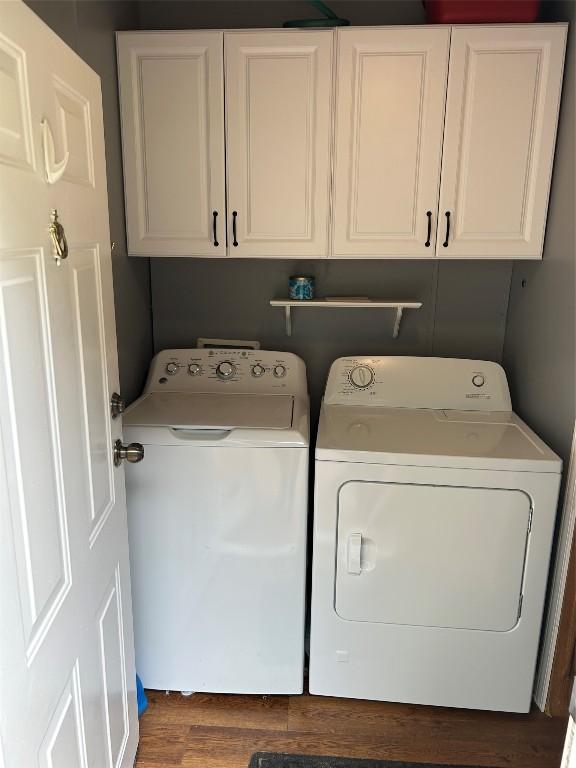 263 W Jamestown Rd, Jamestown, PA 16134 - washroom with washing machine and dryer, cabinet space, and wood finished floors