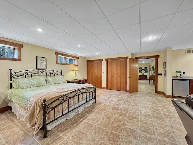 8350 Carbury Rd, Edinboro, PA 16412 - bedroom with fridge, baseboards, two closets, a drop ceiling, and recessed lighting
