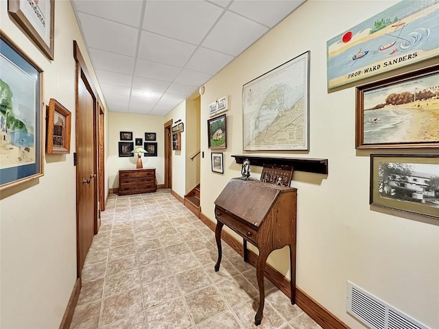 8350 Carbury Rd, Edinboro, PA 16412 - hallway featuring baseboards, a drop ceiling, and light stone finish floors