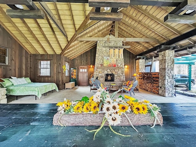 8350 Carbury Rd, Edinboro, PA 16412 - living area with wooden walls, a stone fireplace, beam ceiling, and high vaulted ceiling