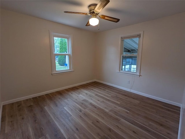 empty room with hardwood / wood-style flooring and ceiling fan