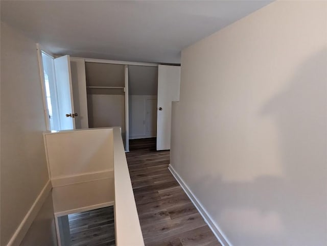 corridor with dark hardwood / wood-style floors