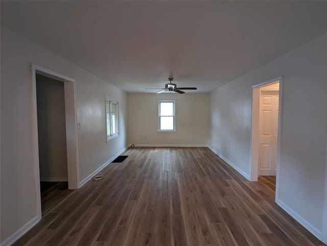 empty room featuring dark hardwood / wood-style floors and ceiling fan