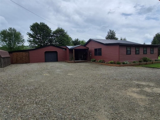 26418 State Highway 18, Albion, PA 16401 - view of front facade with gravel driveway, a garage, and an outdoor structure
