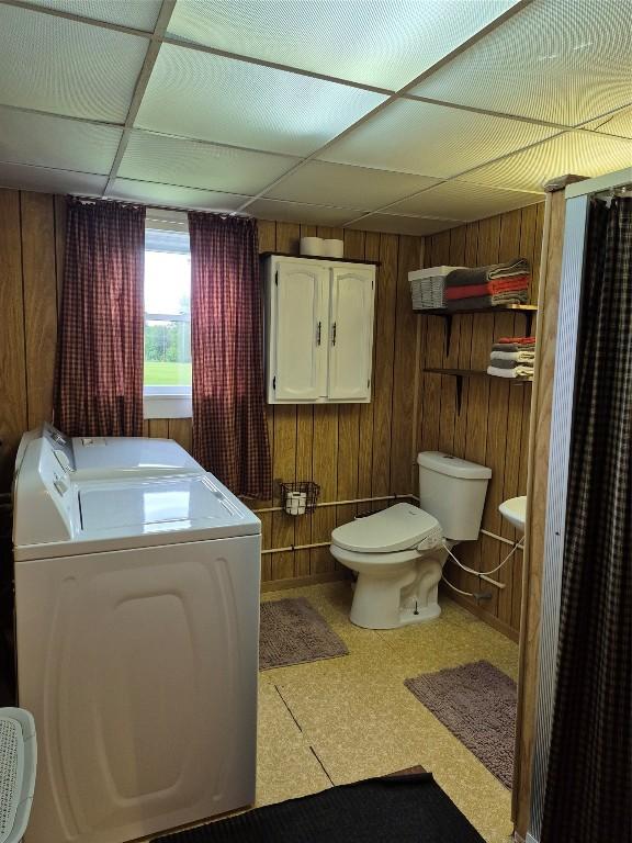 26418 State Highway 18, Albion, PA 16401 - full bathroom with washing machine and dryer, tile patterned floors, wood walls, and a drop ceiling
