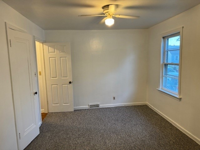 carpeted empty room with ceiling fan