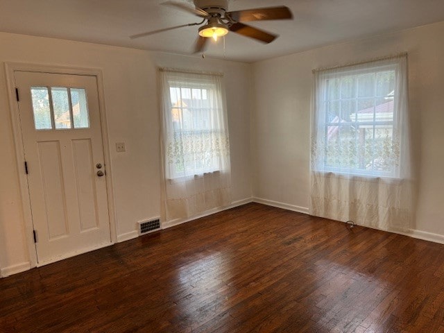 foyer entrance featuring ceiling fan and dark wood-type flooring