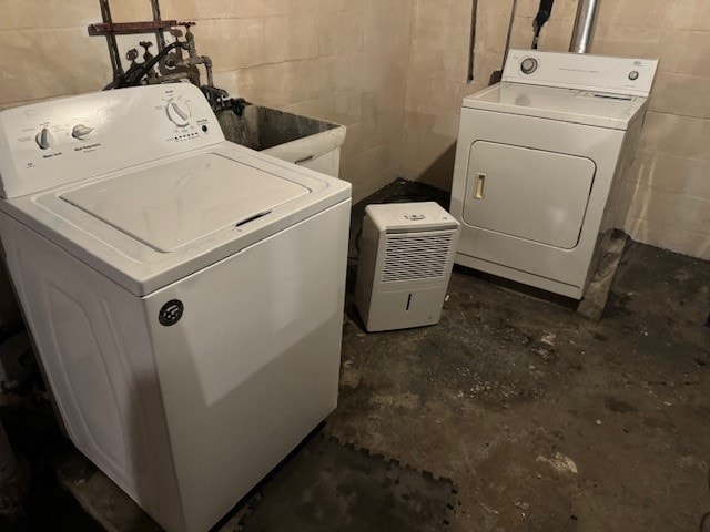 laundry area with washer and clothes dryer and sink