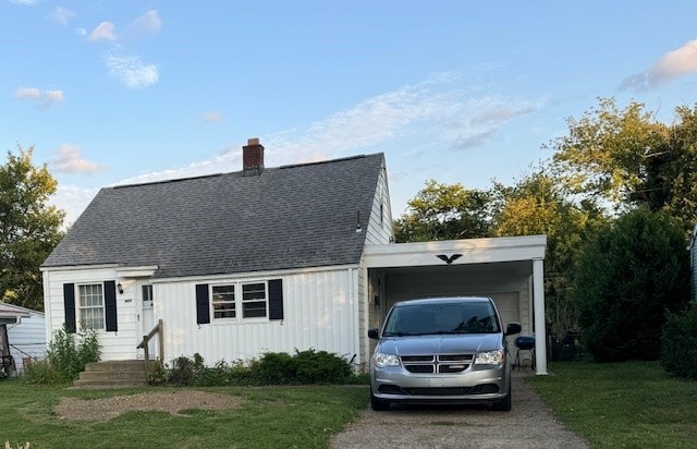 view of front of home with a front yard and a carport