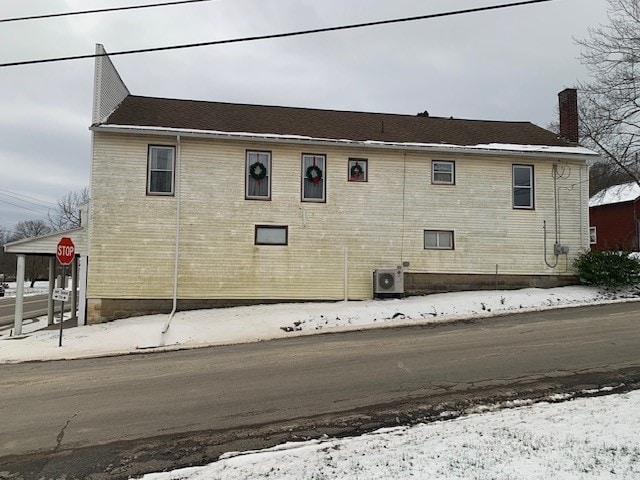 snow covered property featuring cooling unit