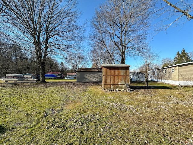 view of yard with an outbuilding and a shed