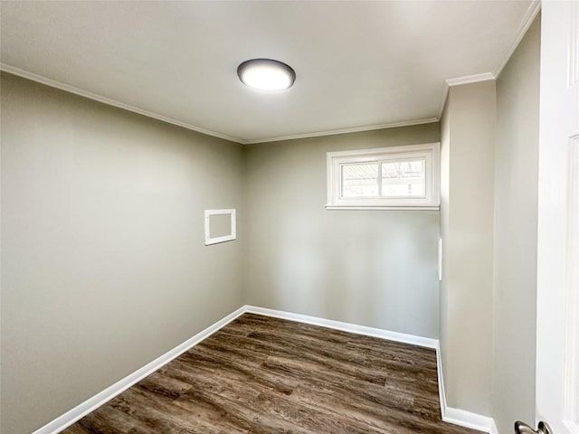 spare room with dark wood-style floors, ornamental molding, and baseboards