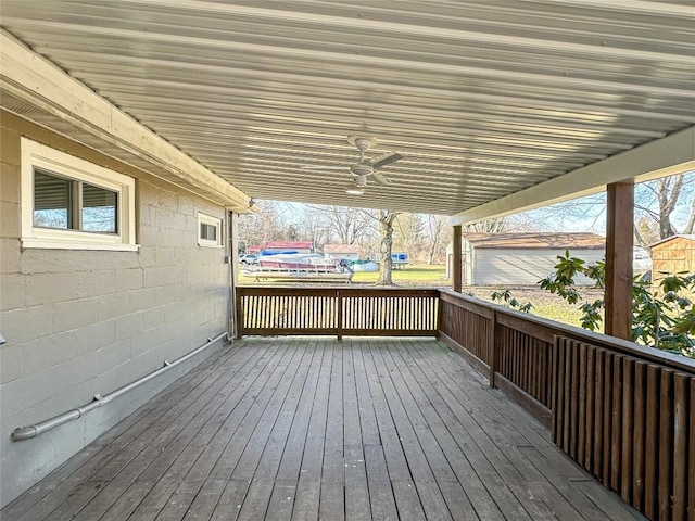 wooden terrace featuring a ceiling fan