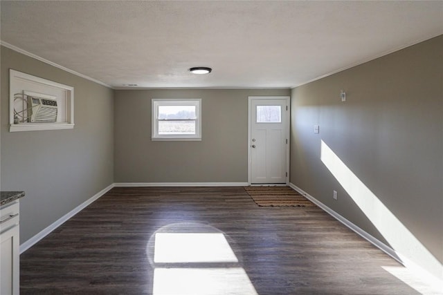 foyer entrance featuring dark wood-style floors, baseboards, and ornamental molding