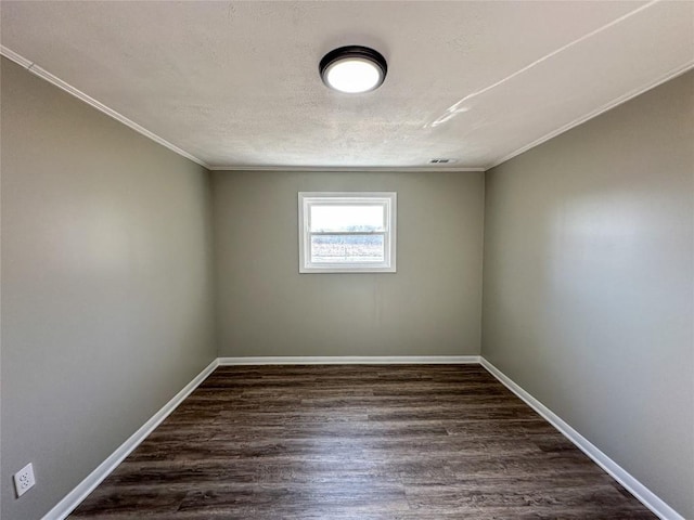 spare room with dark wood-style floors, baseboards, and a textured ceiling