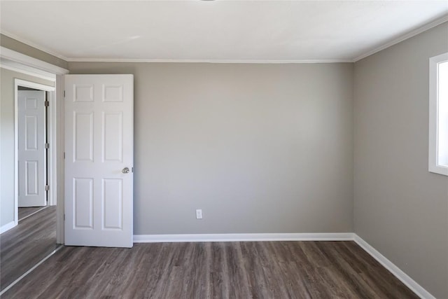 empty room with baseboards, wood finished floors, and ornamental molding