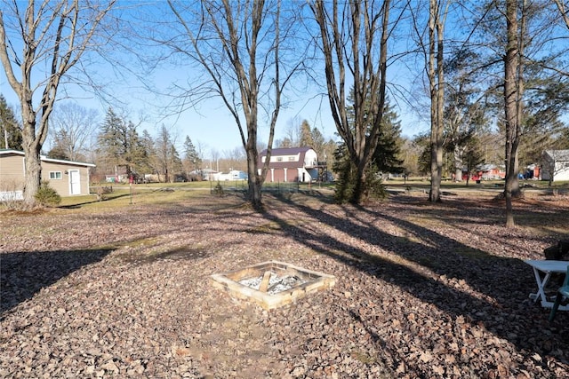 view of yard with an outdoor fire pit