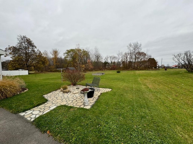 view of yard with a fire pit and a patio area