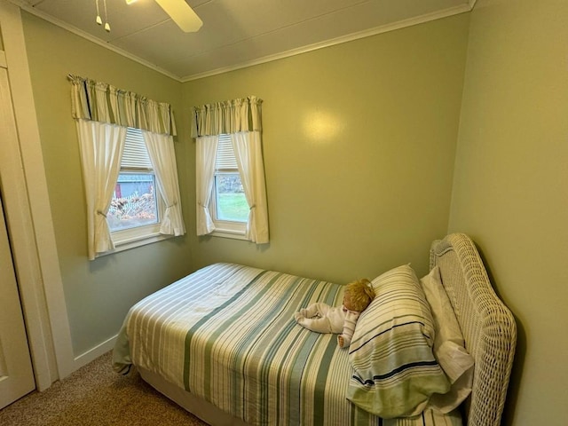 bedroom featuring carpet, ceiling fan, and ornamental molding