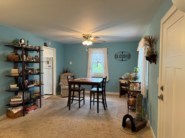 dining room featuring light colored carpet and ceiling fan