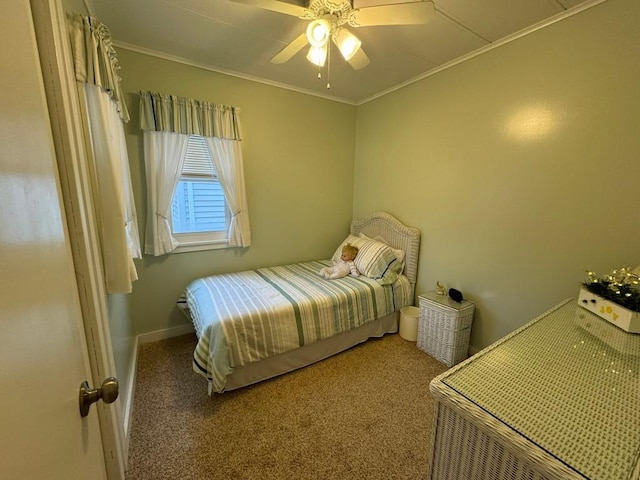 carpeted bedroom featuring ceiling fan and crown molding