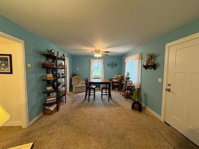 carpeted dining space featuring ceiling fan