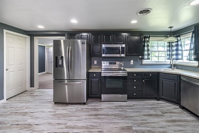 10220 Barton Rd, Waterford, PA 16441 - kitchen with appliances with stainless steel finishes, light countertops, light wood-style floors, dark cabinets, and recessed lighting