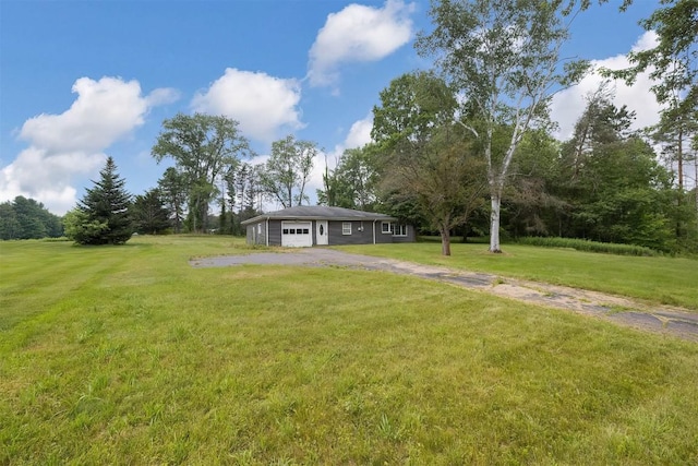 10220 Barton Rd, Waterford, PA 16441 - view of grassy yard featuring asphalt driveway and an attached garage
