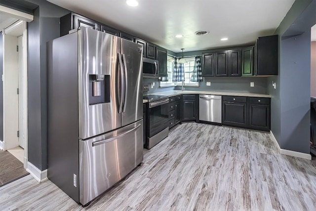 10220 Barton Rd, Waterford, PA 16441 - kitchen with appliances with stainless steel finishes, light wood-style flooring, light countertops, recessed lighting, and dark cabinets