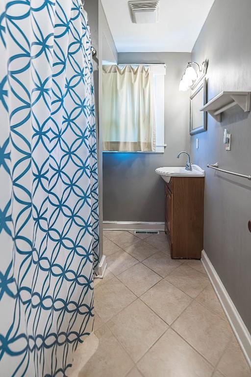 1047 Napier Ave, Erie, PA 16511 - bathroom featuring vanity, tile patterned flooring, baseboards, and a shower with curtain