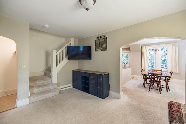 1047 Napier Ave, Erie, PA 16511 - living area featuring arched walkways, light carpet, stairway, baseboards, and a chandelier