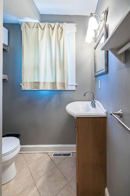 1047 Napier Ave, Erie, PA 16511 - bathroom featuring vanity, toilet, tile patterned flooring, and baseboards