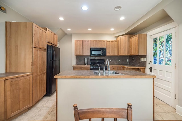 1047 Napier Ave, Erie, PA 16511 - kitchen featuring black appliances, a sink, recessed lighting, decorative backsplash, and a kitchen island with sink