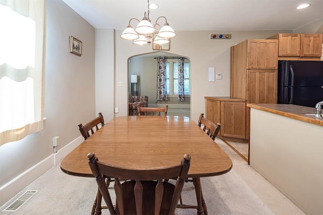 1047 Napier Ave, Erie, PA 16511 - dining space with arched walkways, light colored carpet, recessed lighting, and a chandelier