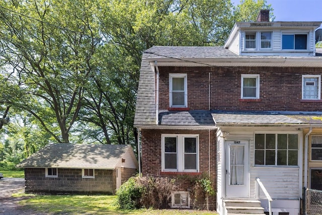 1047 Napier Ave, Erie, PA 16511 - view of front of property featuring entry steps, a chimney, brick siding, and an outbuilding
