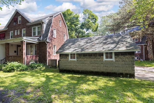 1047 Napier Ave, Erie, PA 16511 - view of home's exterior featuring a lawn, a gambrel roof, and brick siding
