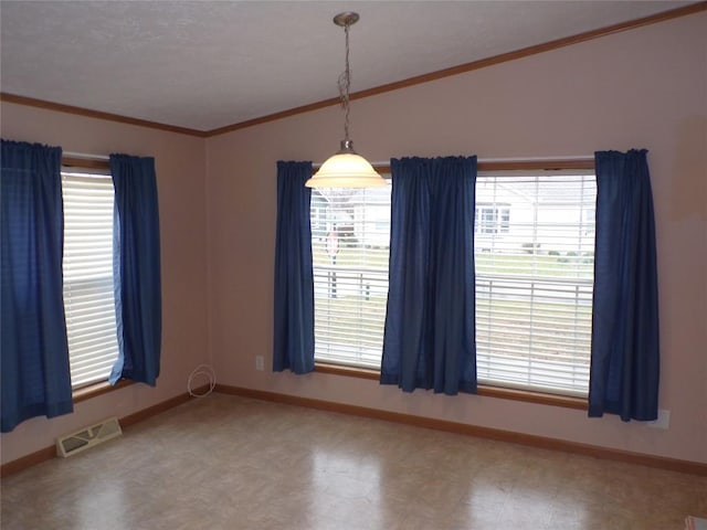 unfurnished room featuring crown molding