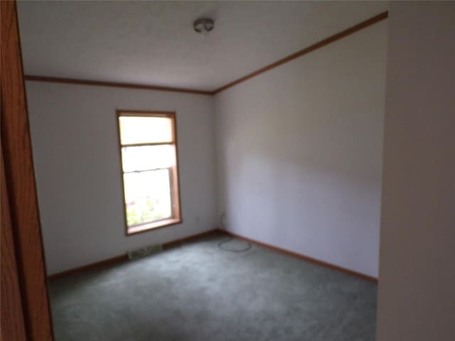 carpeted spare room with crown molding