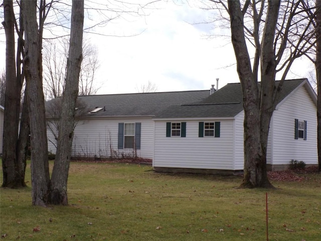 rear view of property with a yard