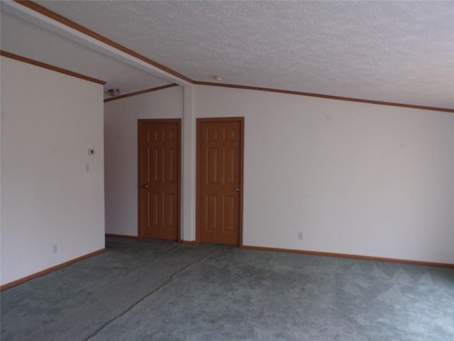 carpeted spare room with a textured ceiling, vaulted ceiling, and ornamental molding