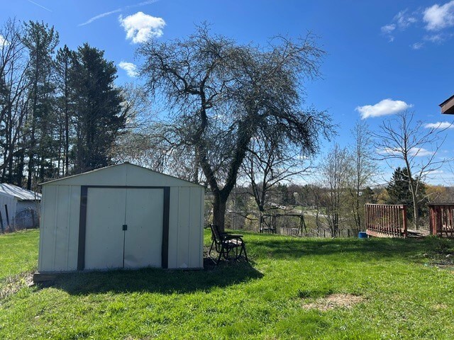 view of yard with an outdoor structure and a shed